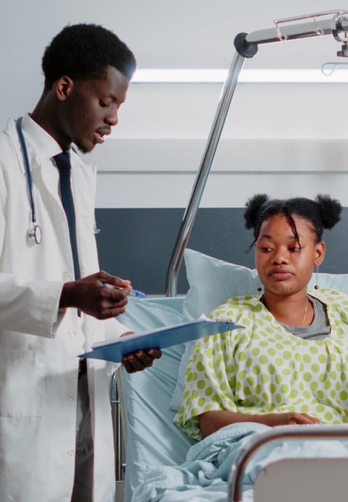 A doctor is talking to a patient in the hospital.